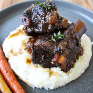 short ribs on mashed potatoes on plate