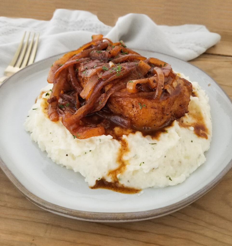 french onion pork chops on mashed potatoes