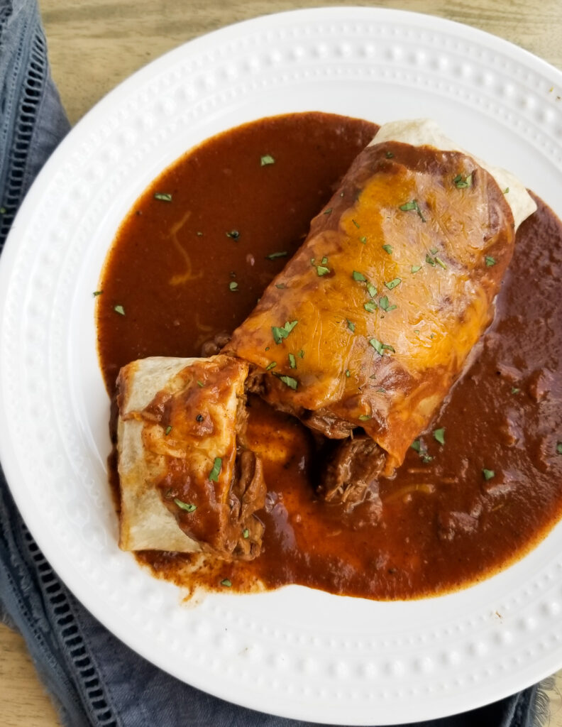 Chile colorado burrito with wet sauce