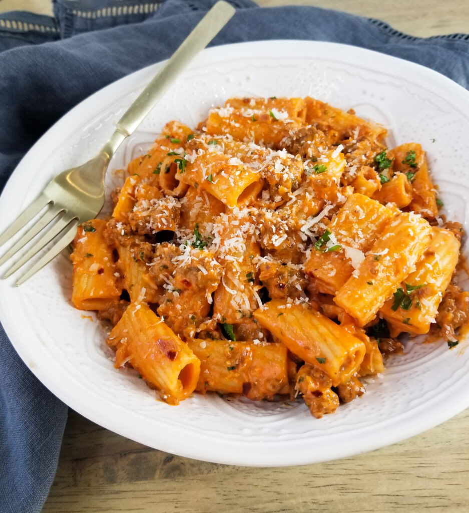 spicy rigatoni pasta in white bowl
